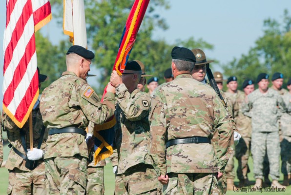 Brig. Gen. Miles Davis, commander of the 98th Training Division (Initial Entry Training), passes the division colors to Command Sgt. Maj. Todd Priest, division command sergeant major, during an assumption of command ceremony on September 11 at the National Infantry Museum at Fort Benning, Georgia. The 98th Training Division is an Army Reserve unit headquarterd at Fort Benning and is one of two divisions that provide drill sergeants who help mold future Soldiers.